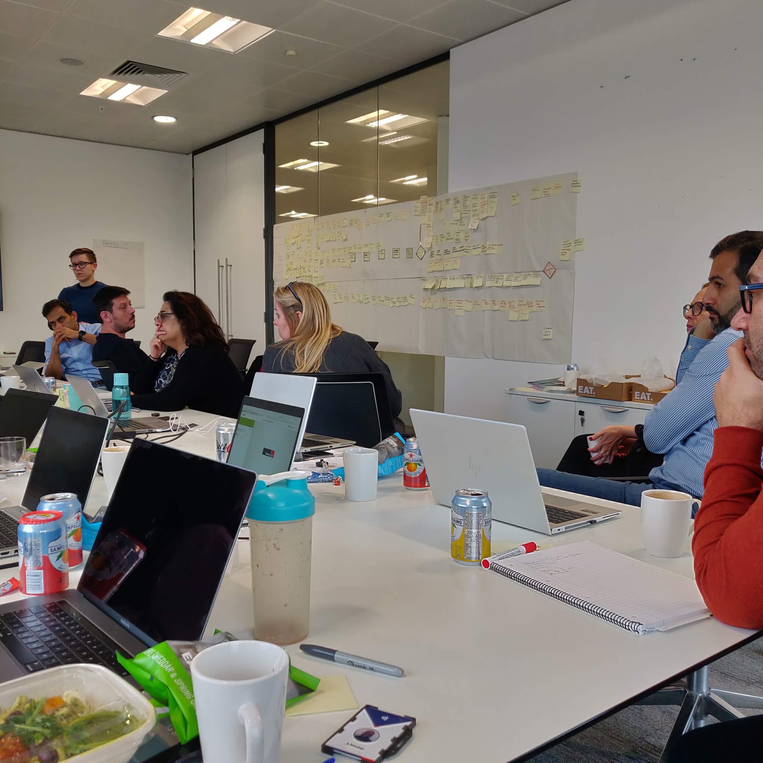 Travelex roadmap workshop — team aligned around a service blueprint with sticky notes